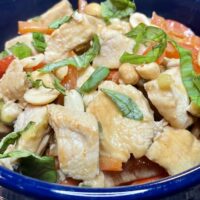 Thai peanut chicken recipe prepared in bowl.