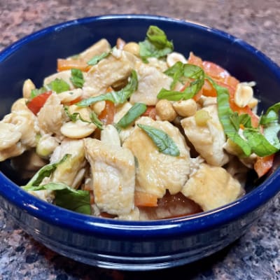 Overhead view of Thai peanut chicken recipe, prepared in bowl.
