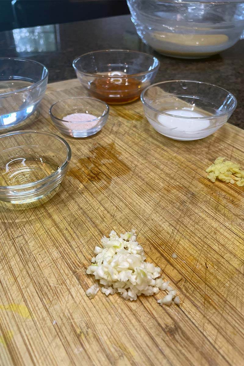 Ingredients for Chinese honey chicken on a cutting board.