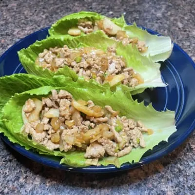 Overhead view of Asian lettuce wraps prepared on plate.