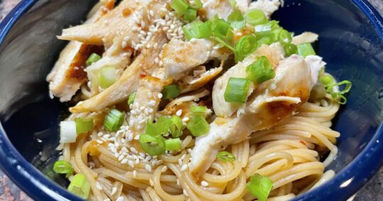 Close up, overhead view of sesame noodles with chicken.