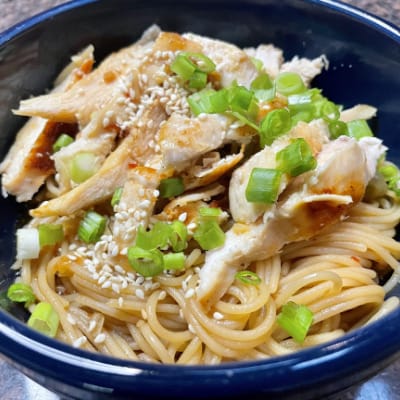 Close up, overhead view of sesame noodles with chicken.