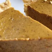 Two slices of prepared pumpkin pie recipe on a plate.