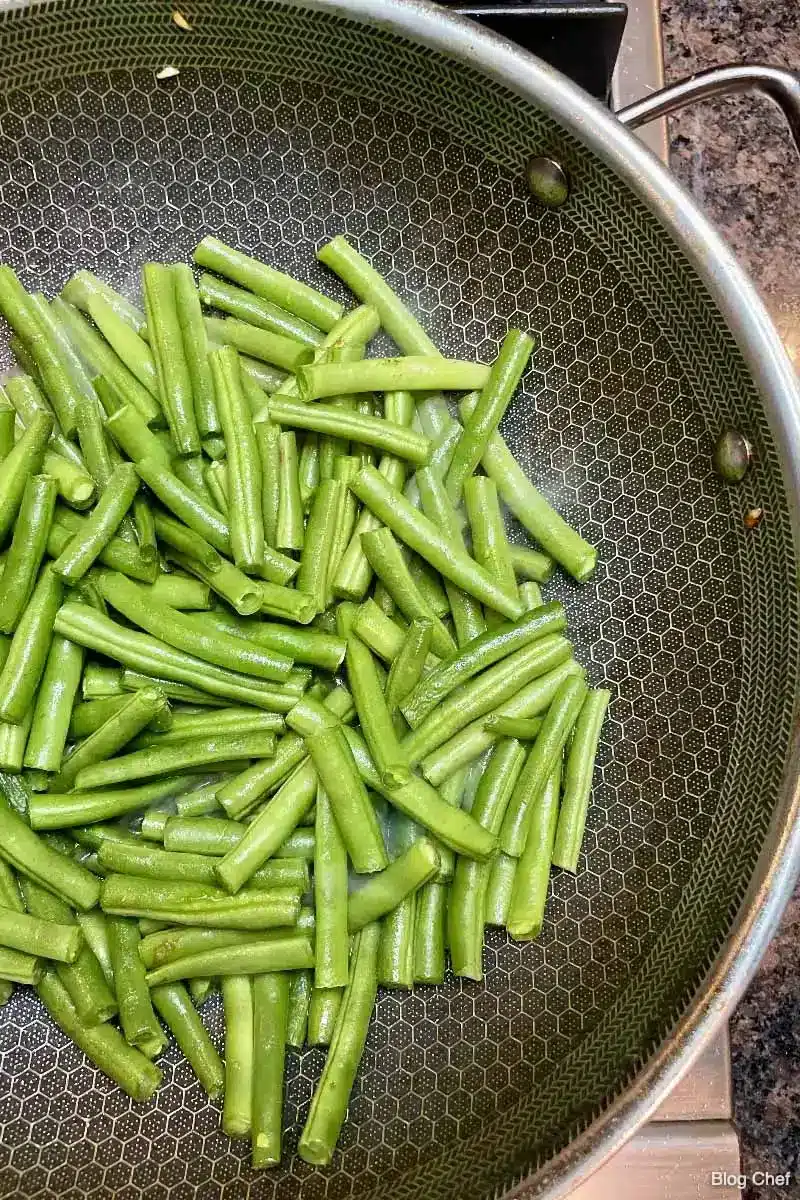 Green beans in a wok.