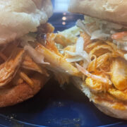 Close up view of buffalo chicken sliders on plate.