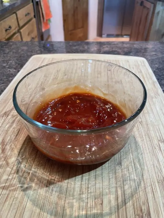 Honey glaze for grilled pork chops in a bowl.