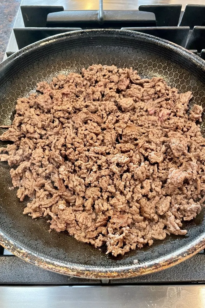 Ground beef cooked in a skillet for crunchy baked tacos. 