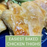 Baked chicken thighs, prepared on blue plate.