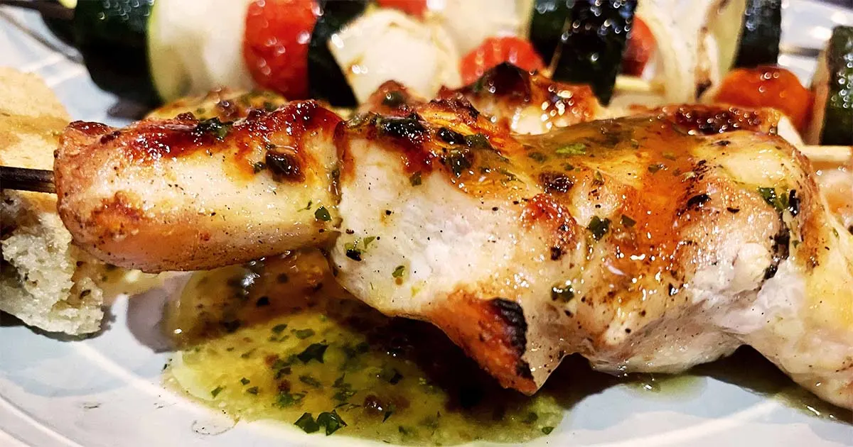 Grilled chicken skewers with roasted garlic vinaigrette.