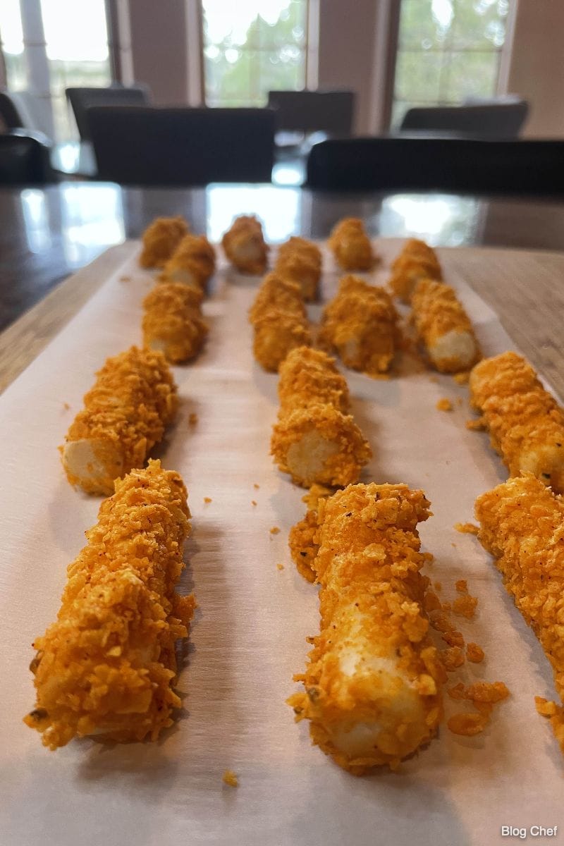 Mozzarella sticks coated with Doritos before being fried.