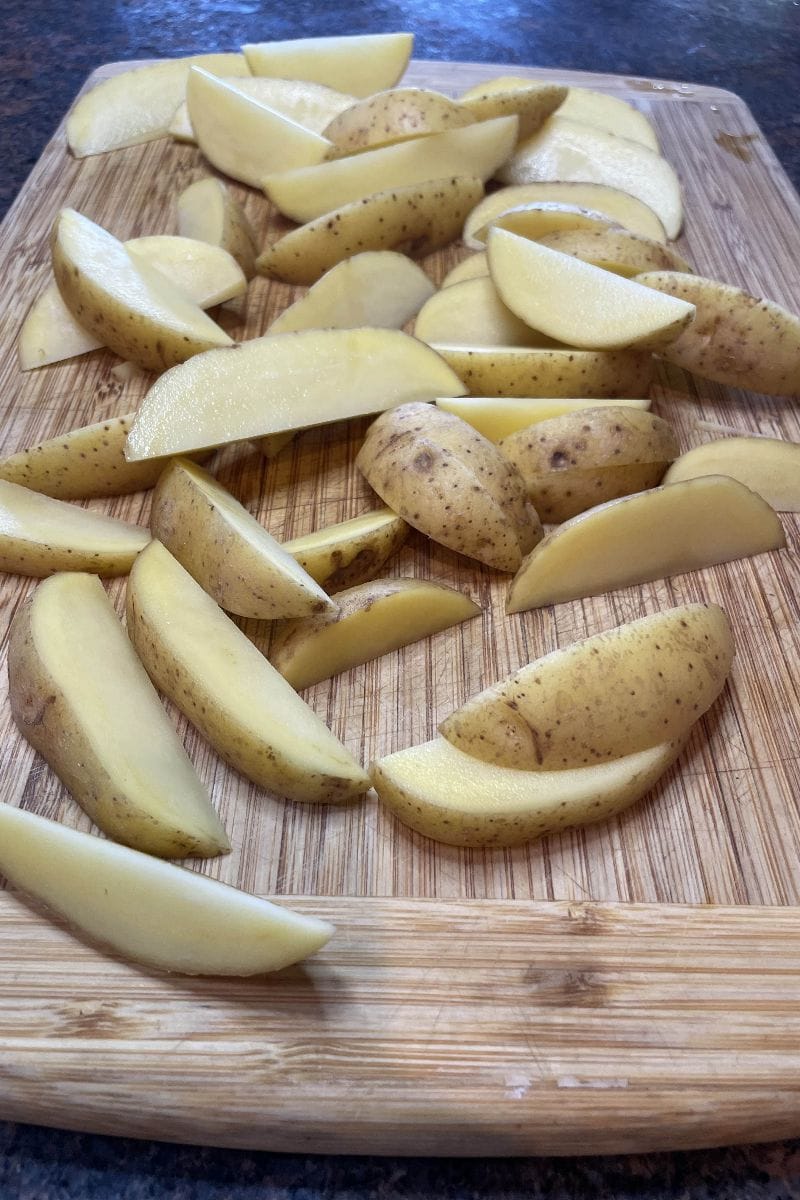 Raw potatoes cut into wedges.