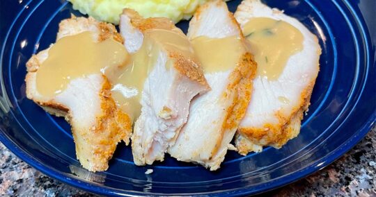 Slow cooker turkey breast, prepared and sliced with gravy.
