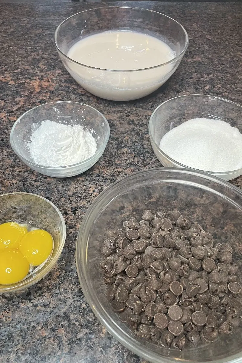 Ingredients for Hershey's chocolate pie, chocolate chips,egg yolks, sugar, milk, and cornstach. 