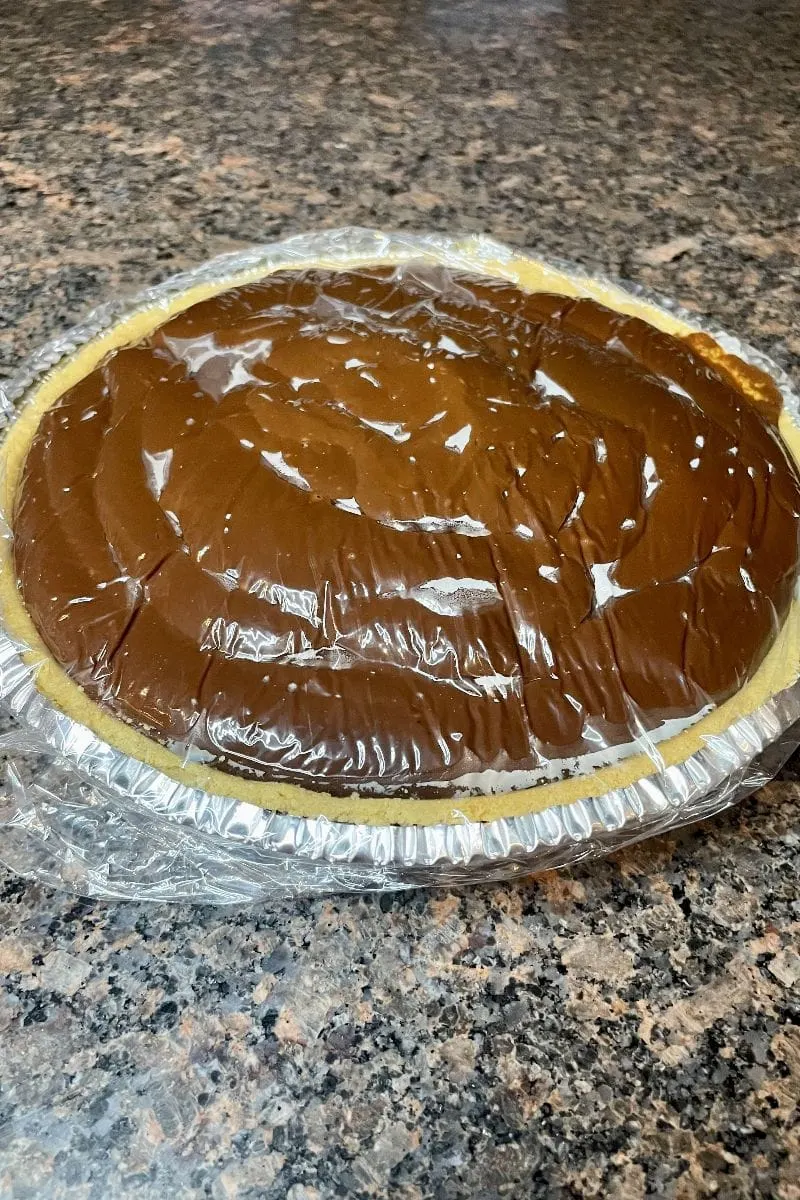 Hershey's chocolate pie covered in plastic wrap.
