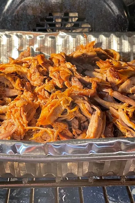Pulled pork in the oven after shredding and adding BBQ sauce.
