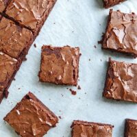 Brownie squares made with substitutes for vegetable oil on parchment paper.