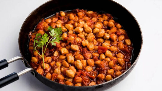 Top view of seasoned garbanzo beans in a skillet.