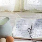 Cookbook propped up on cookbook holder in kitchen.