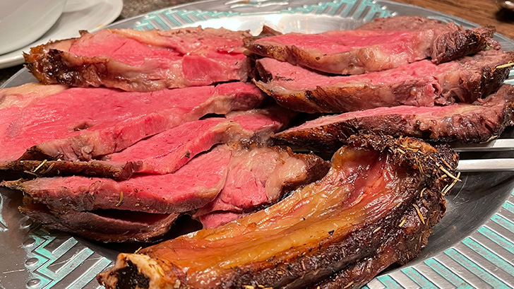 Close-up view of sliced prime rib reverse sear cooked to medium rare.
