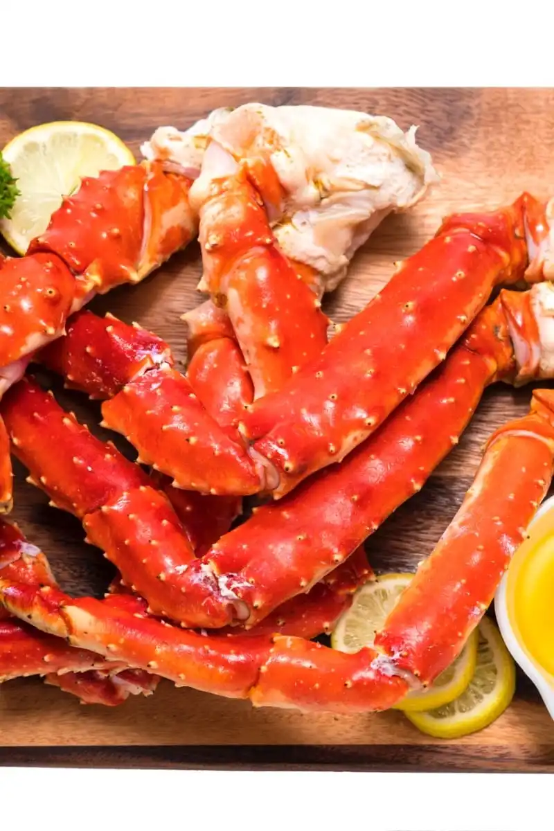 Cooked crab legs with melted butter.