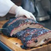 Prepared, sliced brisket on cutting board.