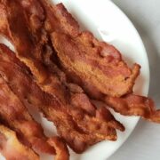 Plate of crispy, cooked bacon.