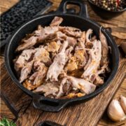 Pulled pork, made in a crockpot, in cast iron serving pan.