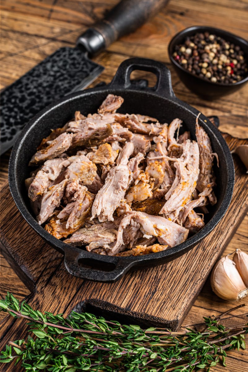 Pulled pork, made in a crockpot, in cast iron serving pan.