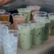 Multiple prepared taro tea drinks on table.