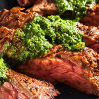 Skirt steak topped with chimichurri.