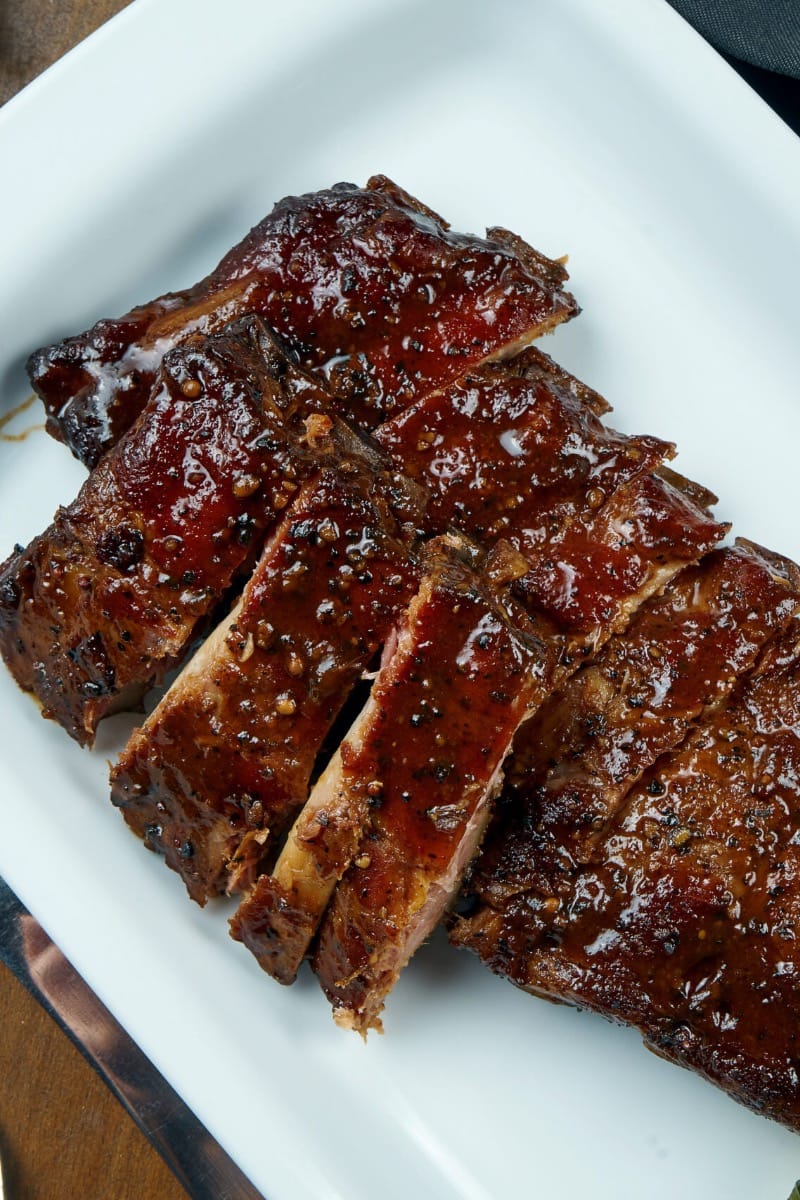 Prepared smoked ribs in serving dish. 