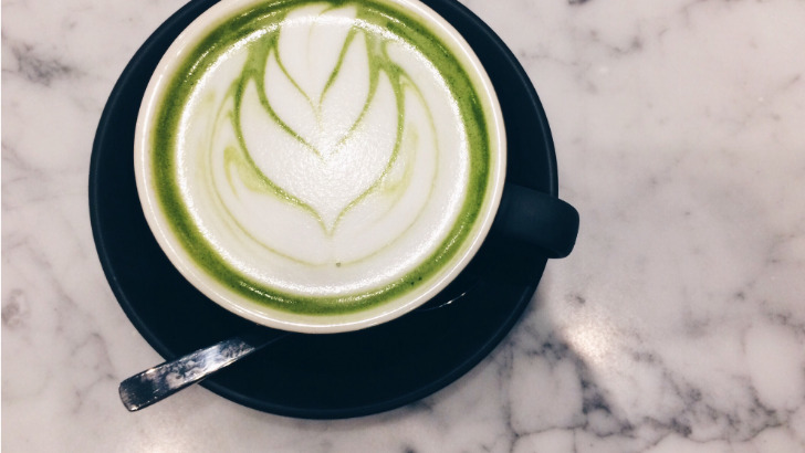 Top view of matcha latte in cup to represent what does matcha taste like at Starbucks?