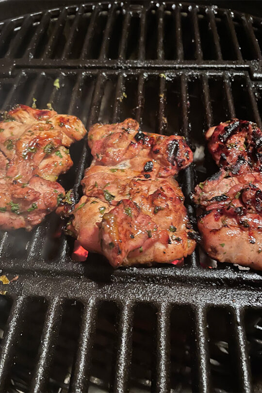 Boneless, skinless chicken thighs on the grill.