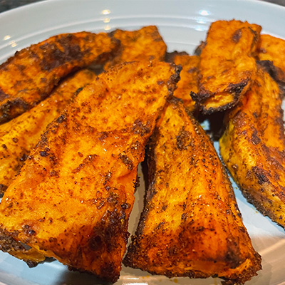 Close up view of oven-roasted yam wedges.
