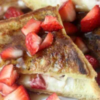 Strawberry cheesecake stuffed French toast on plate.
