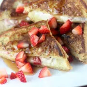 Strawberry cheesecake stuffed French toast on plate.