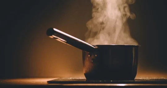 Steaming pot on surface to represent a custom recipe book.