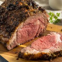 Prime rib roast in a wooden cutting board.